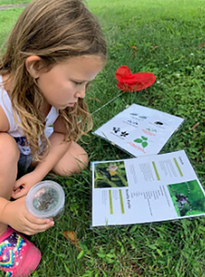 Young girl with nature backpack